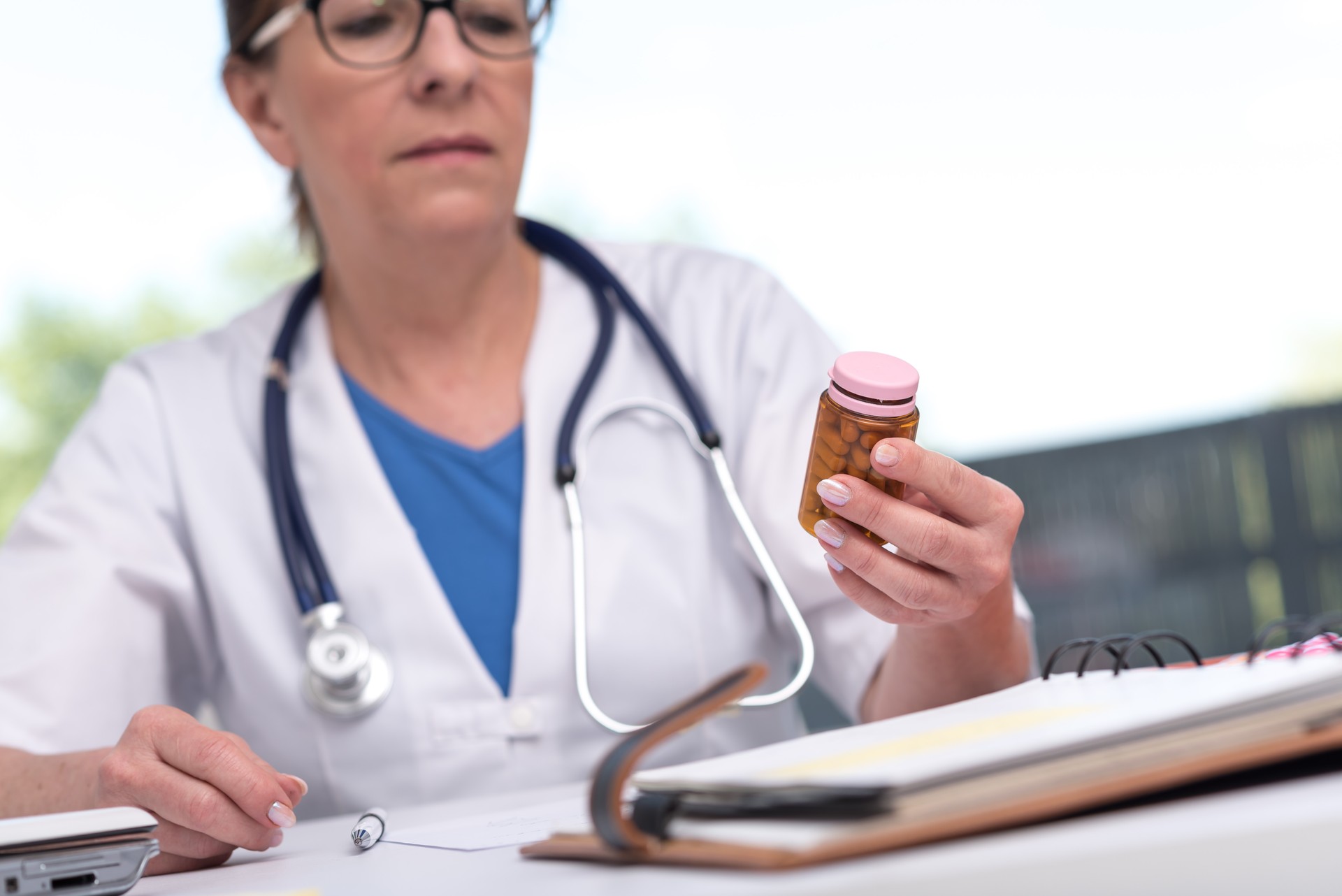 Female doctor holding a bottle of pills