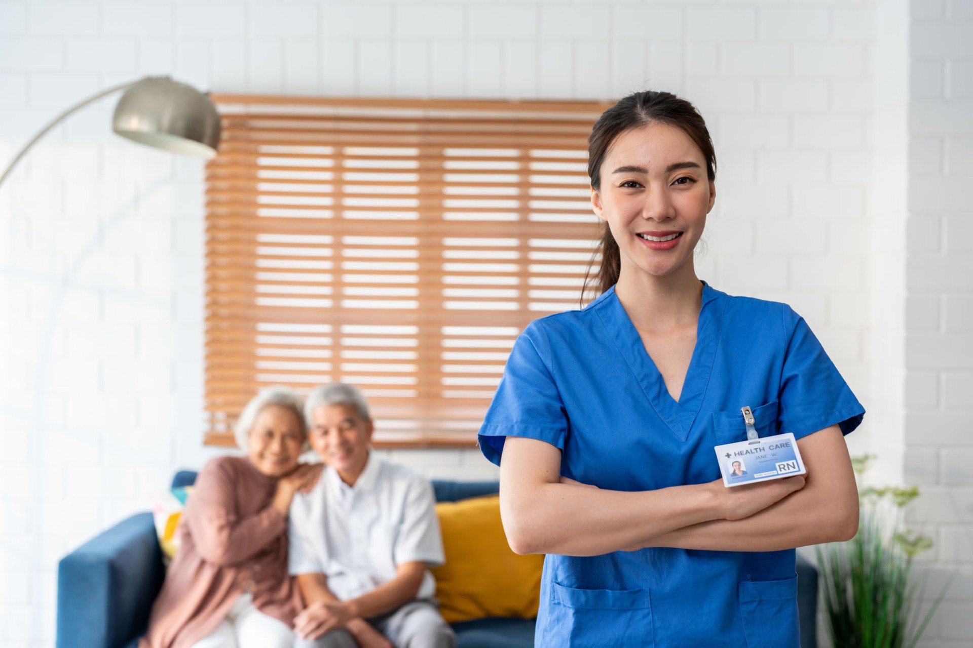 Portrait of Asian beautiful caregiver take care senior couple in house. Attractive specialist carer women support elderly older mature grandparent at nursing home care and smiling, looking at camera.